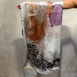 The One of Twelve Wilarra Silk Scarf by Mulyatingki Marney showcases earthy-toned patterns inspired by the Wilarra landscape in Western Australia. Recently, it gained global attention when French survivor Gisèle Pelicot wore it in court, symbolizing healing and solidarity. Gifted by Australia’s Older Women’s Network, the scarf connected her with the Martu community. Widely covered in the media, it highlights Indigenous artistry’s power in storytelling, resilience, and cultural unity.