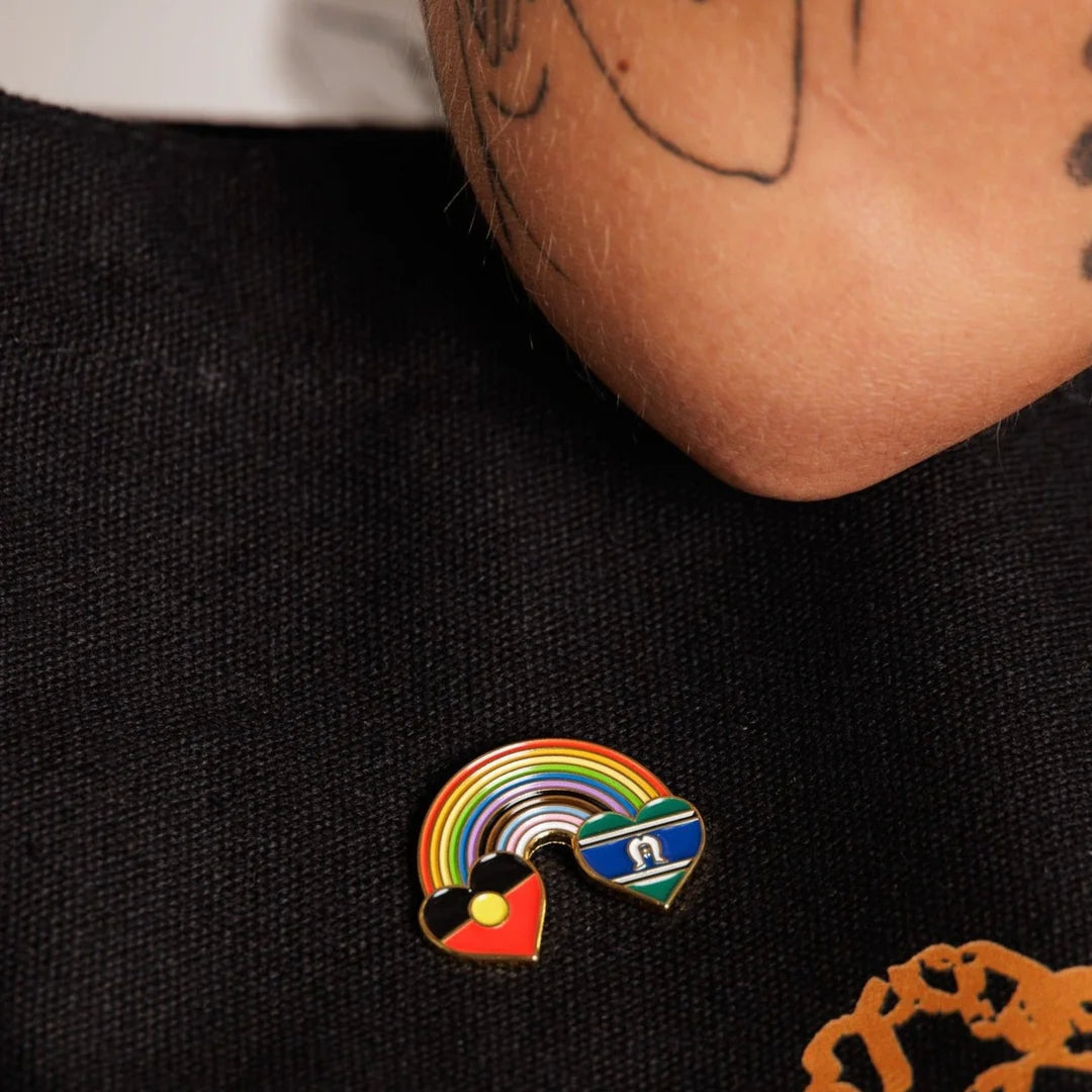 Pin with rainbow design on a black shirt