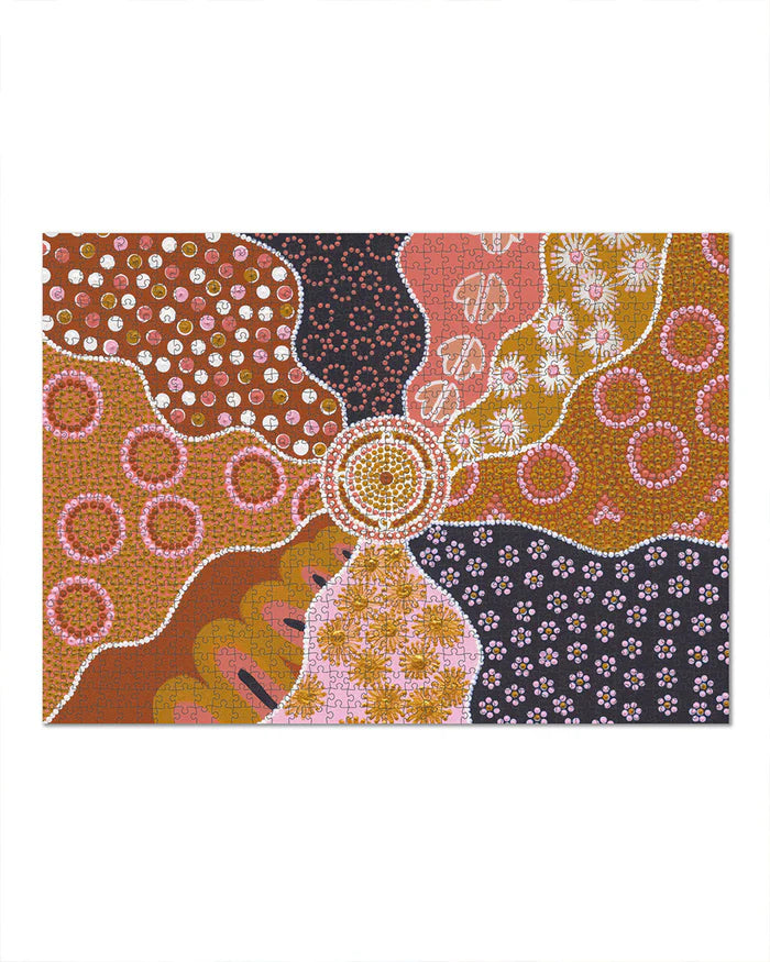 Decorative mat with Aboriginal art design featuring circles and patterns on a white background