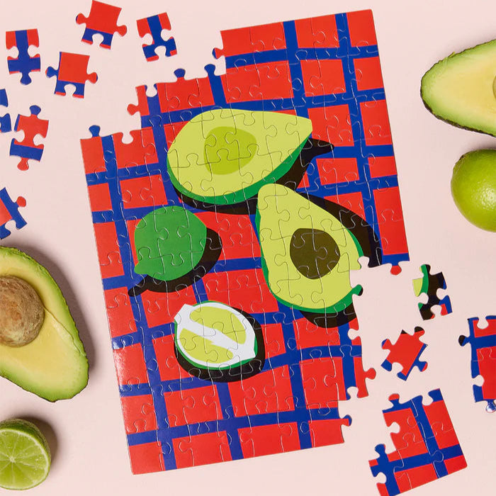 Avocado-themed puzzle with missing pieces on a pink background
