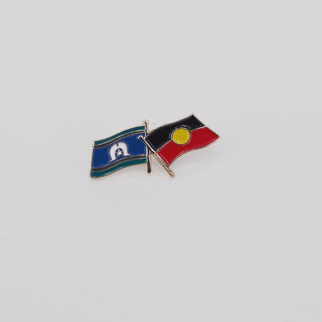 Pin with two crossed flags on a light gray background