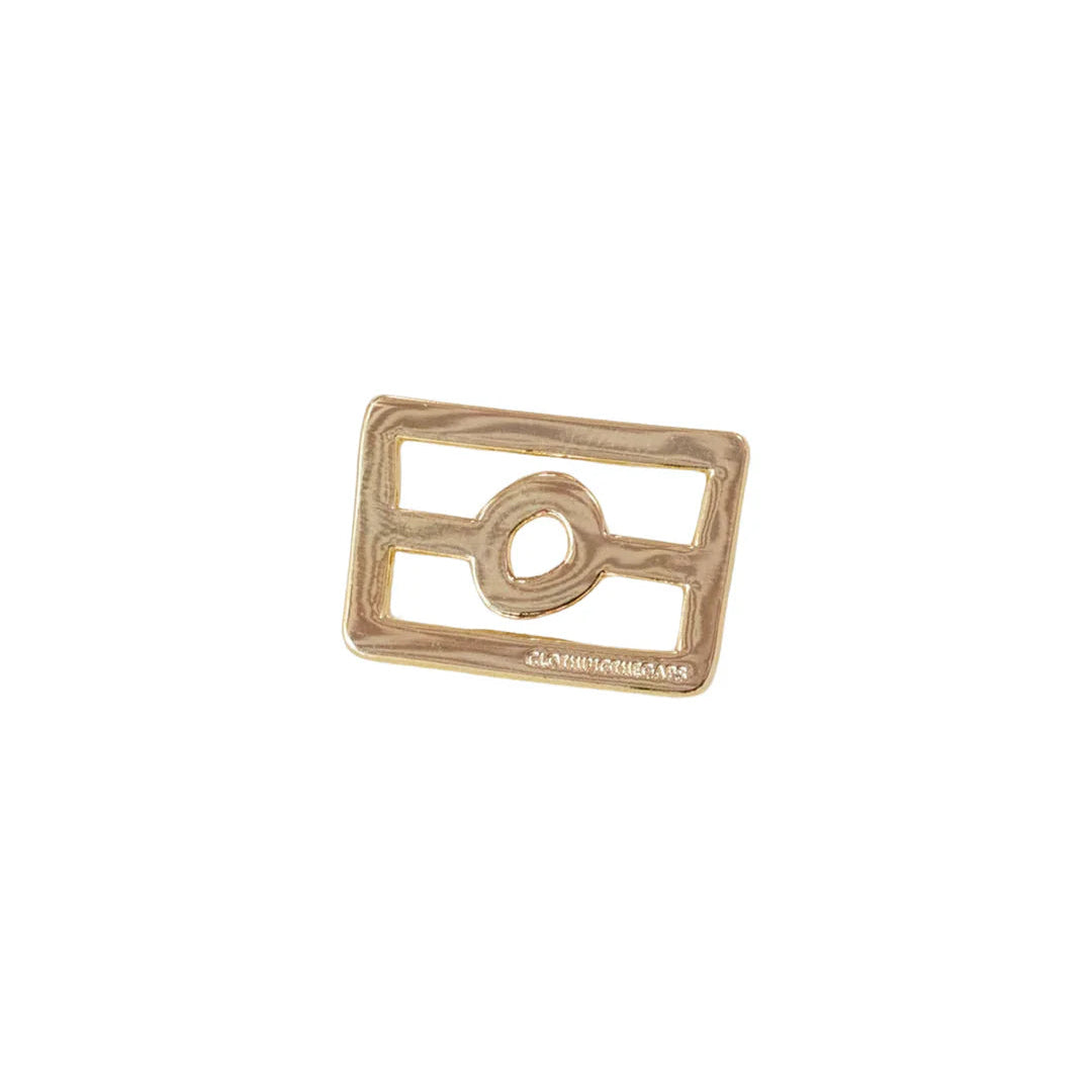Gold-colored metal ring with a rectangular design on a white background