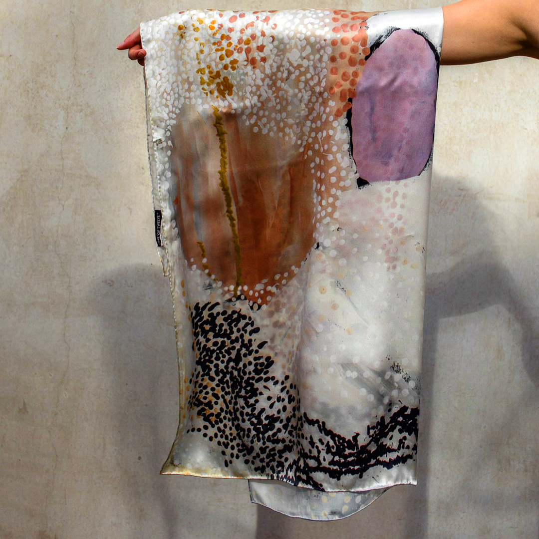 The One of Twelve Wilarra Silk Scarf by Mulyatingki Marney showcases earthy-toned patterns inspired by the Wilarra landscape in Western Australia. Recently, it gained global attention when French survivor Gisèle Pelicot wore it in court, symbolizing healing and solidarity. Gifted by Australia’s Older Women’s Network, the scarf connected her with the Martu community. Widely covered in the media, it highlights Indigenous artistry’s power in storytelling, resilience, and cultural unity.