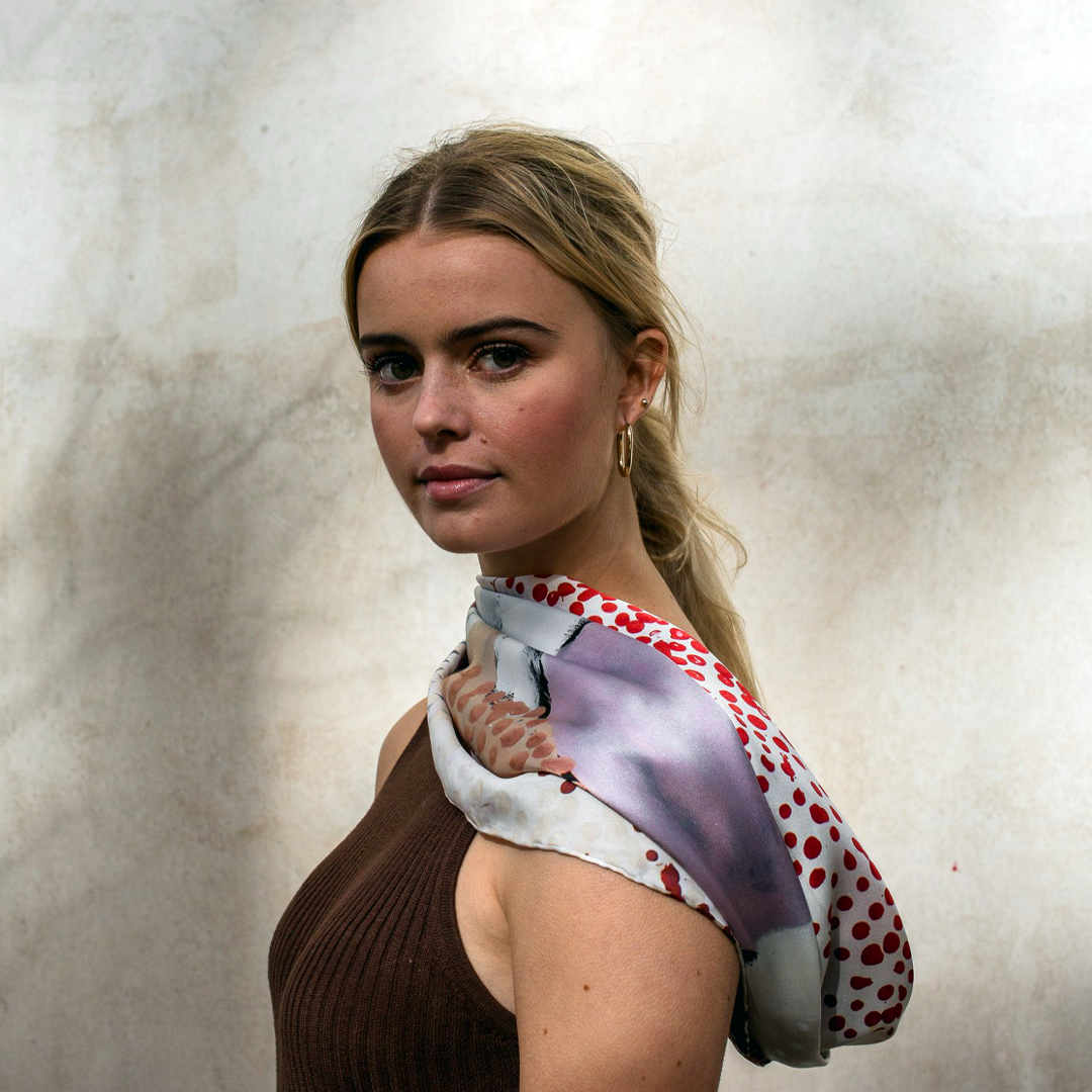 The One of Twelve Wilarra Silk Scarf by Mulyatingki Marney showcases earthy-toned patterns inspired by the Wilarra landscape in Western Australia. Recently, it gained global attention when French survivor Gisèle Pelicot wore it in court, symbolizing healing and solidarity. Gifted by Australia’s Older Women’s Network, the scarf connected her with the Martu community. Widely covered in the media, it highlights Indigenous artistry’s power in storytelling, resilience, and cultural unity.